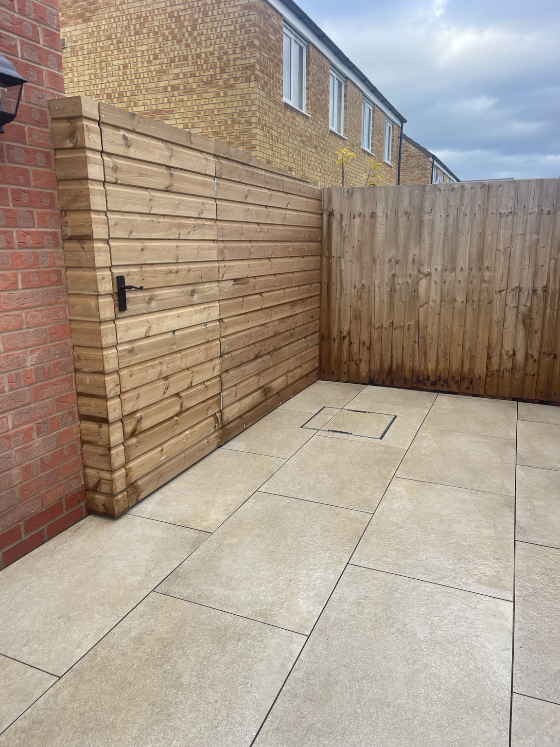 Close view of paving and timber fencing beside the garden room