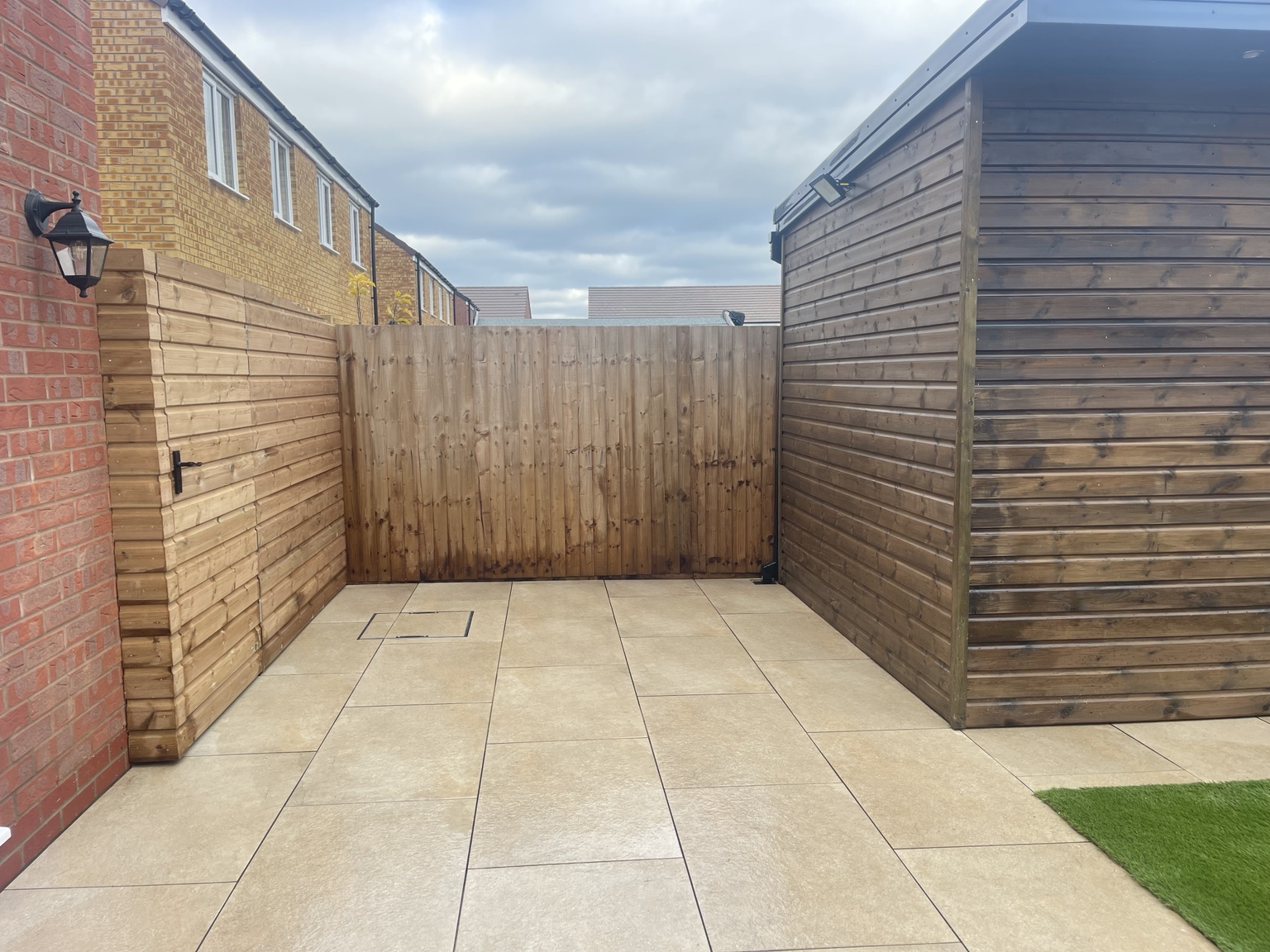 Wide view of the paved patio and timber garden room