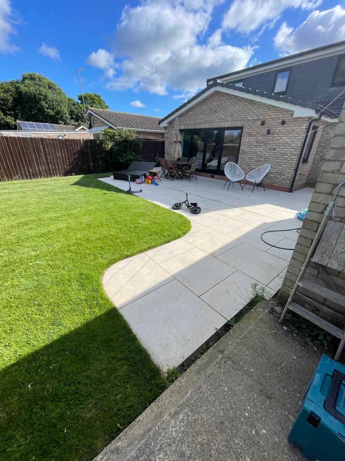 Landscaped lawn beside a curved patio